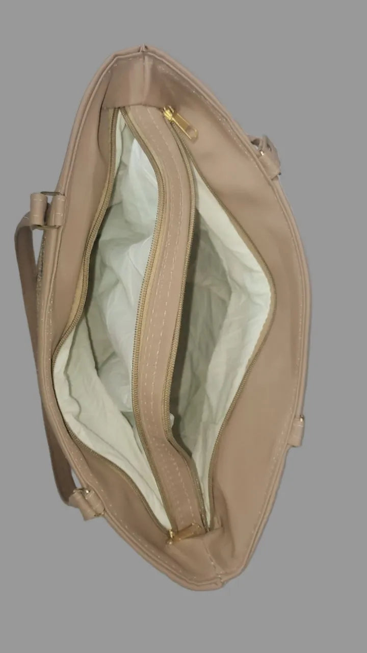 Beige handbag with open front pocket on a gray background