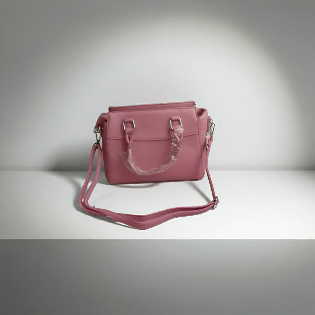 Pink handbag with a strap back side on a gray background
