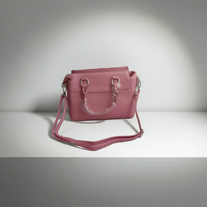 Pink handbag with a strap back side on a gray background