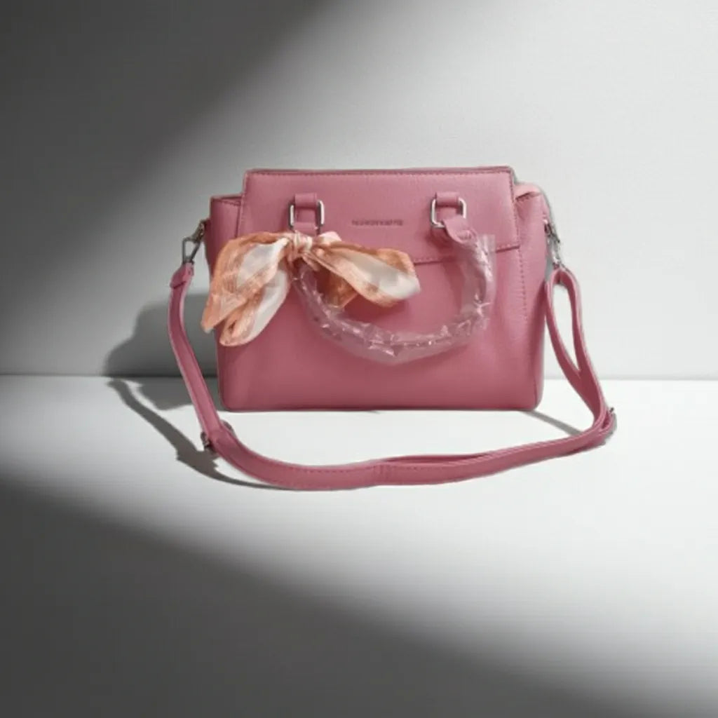 purple fasion handbag with silk bow a floral scarf on a light gray background