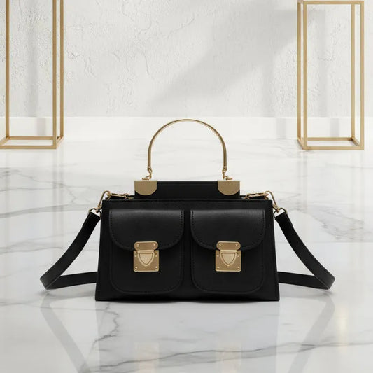 Black handbag with gold accents on a marble surface
