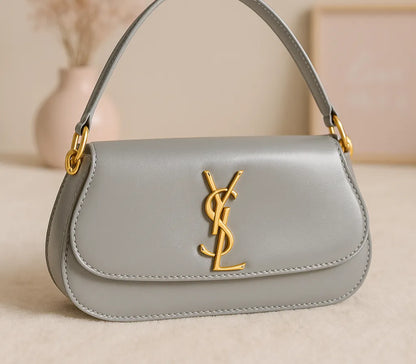 Gray handbag with gold logo on a beige background