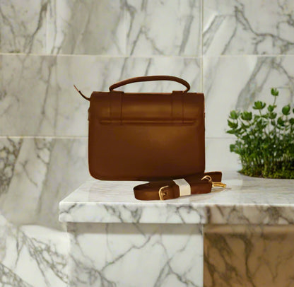 Brown leather handbag with a strap back side