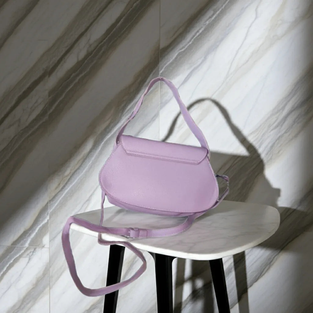 Purple handbag on a white stool against a marble wall