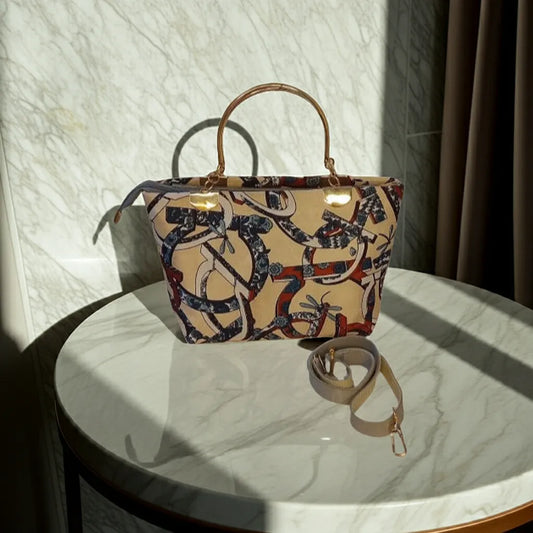 Patterned handbag on a marble surface with sunlight casting shadows