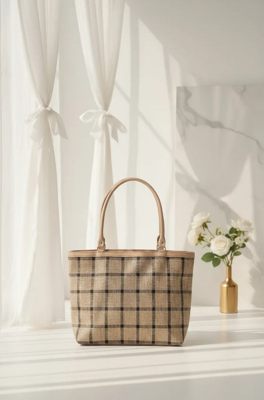 Plaid tote bag on a white surface with a light background