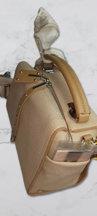 brown handbag with a bow on a light gray background