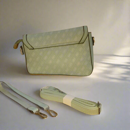 Green handbag with matching strap on a light background