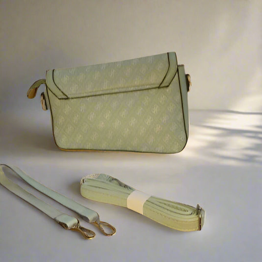 Green handbag with matching strap on a light background