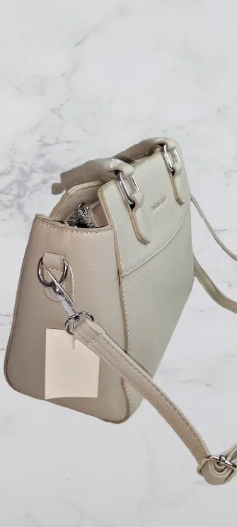 Beige handbag with a strap side view on a light gray background