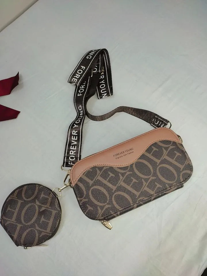 Patterned handbag and pouch with 'Forever Young' strap on a white background