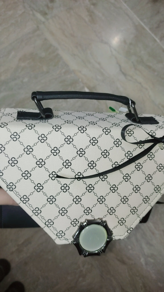 Patterned bag with a handle on a tiled floor