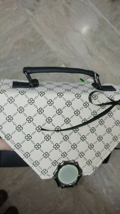 Patterned bag with a handle on a tiled floor