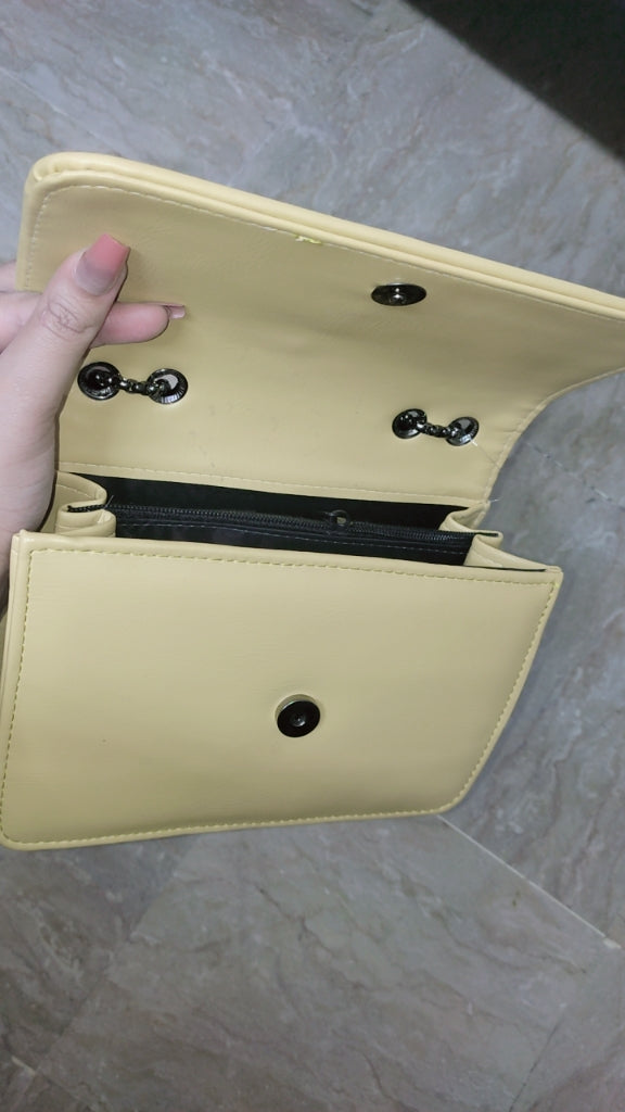 Beige wallet with black interior on a gray surface