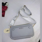 Gray crossbody bag with 'Luce Bella' branding on a white background