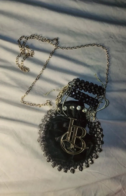 Necklace with a decorative pendant on a textured surface