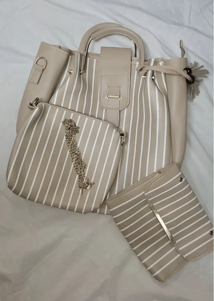 Beige handbag with striped pattern and matching pouch on a light background