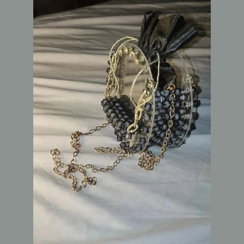 Necklace with beaded pendant and chain on a textured surface