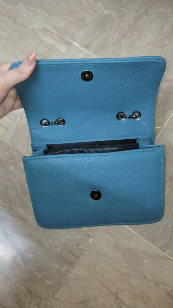 Blue wallet held open on a marble surface