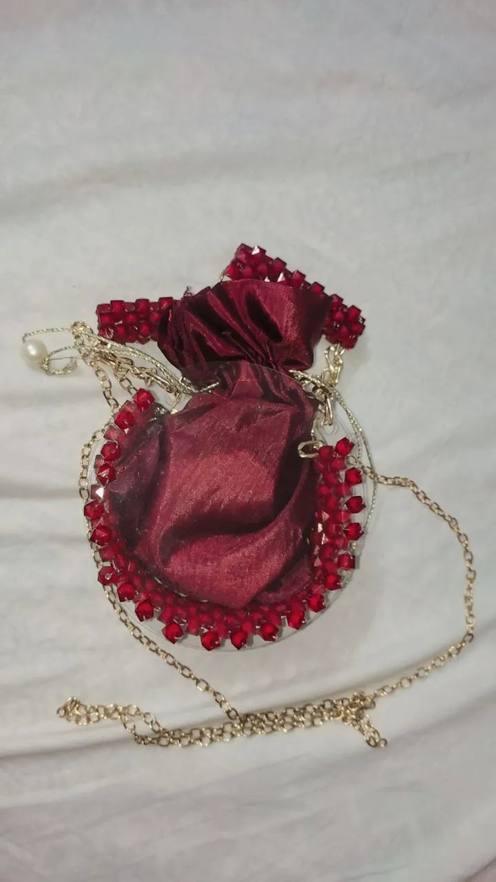 Red velvet bag with gold chain on a white background