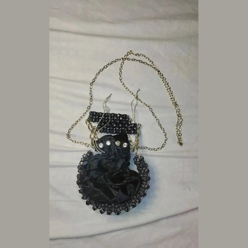 Black cat pendant necklace on a white fabric background