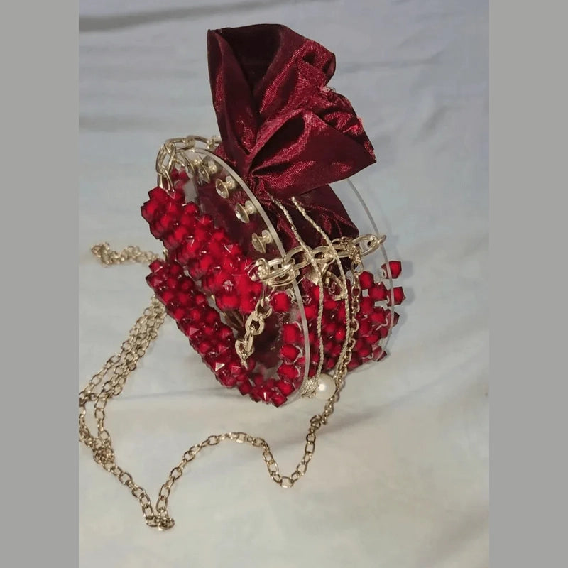 Red heart-shaped bag with gold chain and bow on a white background