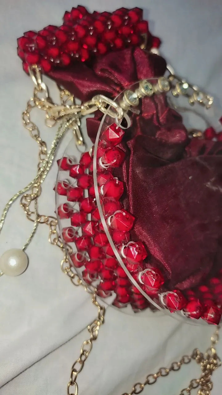Red beaded bag with gold chain on a light background