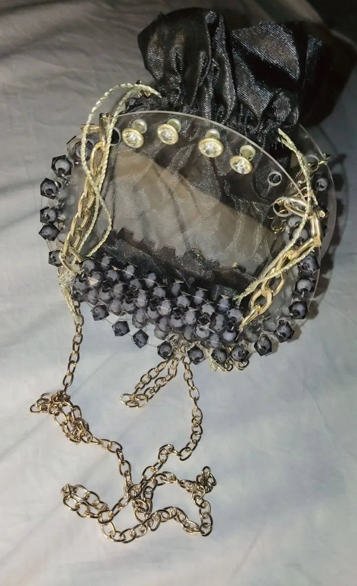 Decorative brooch with pearls and gemstones on a light background