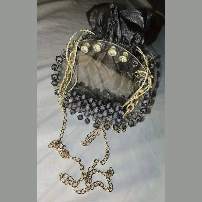 Decorative brooch with pearls and gemstones on a light background